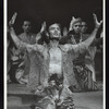 Production shot of cast at end of Act I, Yul Brynner kneeling, arms raised