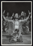 Production shot of cast at end of Act I, Yul Brynner kneeling, arms raised