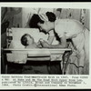 Gypsy Rose Lee bathing four-month-old Erik in 1945.