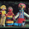 Three large rod puppets by Ronnie Asbell with two small children