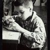 Young boy constructing a puppet