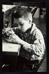 Young boy constructing a puppet