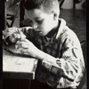 Young boy constructing a puppet