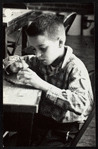 Young boy constructing a puppet