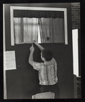 Child measuring the dimensions of a puppet theater set