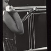 Girl holding grid and pipes of a hand puppet theater set