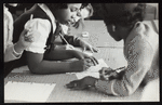 Schoolchildren working on the script for a puppet play