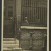 Two figures visible through a building front, possible 152 W. 45th Street