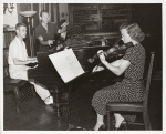 1952 Music Period, woman in polka dot dress playing violin next to two men at piano