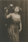 Sophie Tucker holding a rose, at the American Music Hall.
