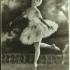 Early full-length studio portrait of Ruth Page on pointe in short tutu and white wig