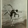 Andreas Pavley  in a Grecian dance, posed on a beach