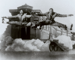 The Nicholas Brothers in side split leaps in front of a stage set featuring a railroad caboose labeled "Chatanooga Choo Choo".