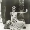 Indrani posed before a temple, dancing in the Bharata Natyam style