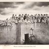 Women watching a procession from a roof
