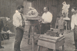 Edward Clark Potter modeling a live wildcat in his studio with three assistants and son Nathan