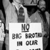 Demonstrator holding "No big brothers in our bedrooms, G.P.U.-N.Y.U." sign
