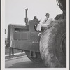 Photograph of Robert Moses seated on a tractor