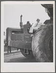 Robert Moses seated on a tractor
