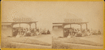 Group of people in front of the ice cream stand.