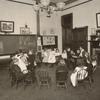 Students seated in a circle, shaking hands
