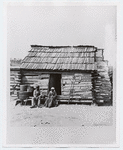 Slaves in front of a cabin