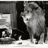 Mack Sennett (as himself) with lion in the motion picture Down Memory Lane.