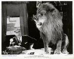 Mack Sennett (as himself) with lion in the motion picture Down Memory Lane.