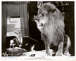 Mack Sennett (as himself) with lion in the motion picture Down Memory Lane.