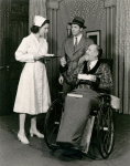 "Mary Wickes, unidentified actor and Monty Woolley (in wheelchair) in The Man Who Came to Dinner."