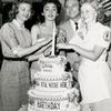 Publicity photo of Jack Cassidy and three unidentified women celebrating the one year anniversary of the stage production Wish You Were Here.