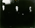Ray Milland (center) with unidentified actor and actress in the motion picture Ministry of Fear.