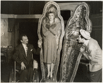 Moss Hart, in wheelchair, with two unidentified others and a coffin (The Man Who Came To Dinner)