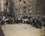 Children playing in street under adult supervision