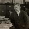 Portrait of Frank Sprague seated at desk