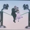 Man and woman sit on telephone wire