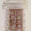 Woman peering through a barred window, Cuba?