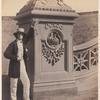 Man leaning on the newel at the base of the Bethesda Terrace staircase