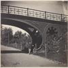Man standing under Central Park bridge
