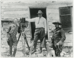 Oscar Micheaux (center) with an actor and possibly a crew member