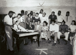Group portrait of members of the American Negro Theatre including Sidney Poitier (4th from left), Robert Earl Jones, seated (3rd from right), and Hilda Haynes, seated, middle.