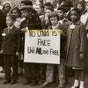 Mixed race group of children carrying sign: "No Child is Free Until ALL are Free," circa early 1960s