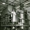 Dr. Percy L. Julian, scientist, checking equipment in the Glidden Paint and Varnish plant, Chicago, Illinois