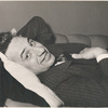 Elia Kazan smiling and lying on sofa.