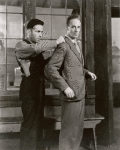 Humphrey Bogart (as Duke Mantee) measuring Leslie Howard (as Allan Squire) in The Petrified Forest