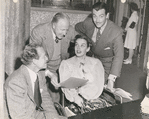 Robert Taylor (standing at right) with unidentified cast members