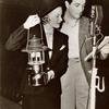 Robert Taylor and Jean Chatburn reading for NBC's Good News of 1938 radio program during a studio blackout caused by California floods.