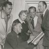 Unidentified man, producer Bill Doll, playwright Ouida Rathbone, director Reginald Denham, and Basil Rathbone during preparation for the stage production Sherlock Holmes