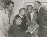 Unidentified man, producer Bill Doll, playwright Ouida Rathbone, director Reginald Denham, and Basil Rathbone during preparation for the stage production Sherlock Holmes