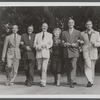 Publicity photo of director Reginald Denham, producer Bill Doll, Jack Raine, playwright Ouida Rathbone, Basil Rathbone, and unidentified man from the stage production Sherlock Holmes